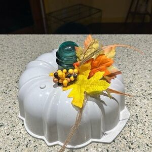 Handmade pumpkin made out of a white bunt cake pan.